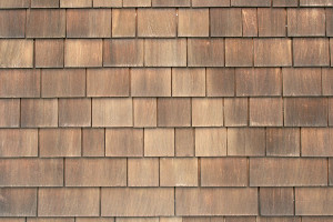 brown and weathered wood shingles on a vertical wall